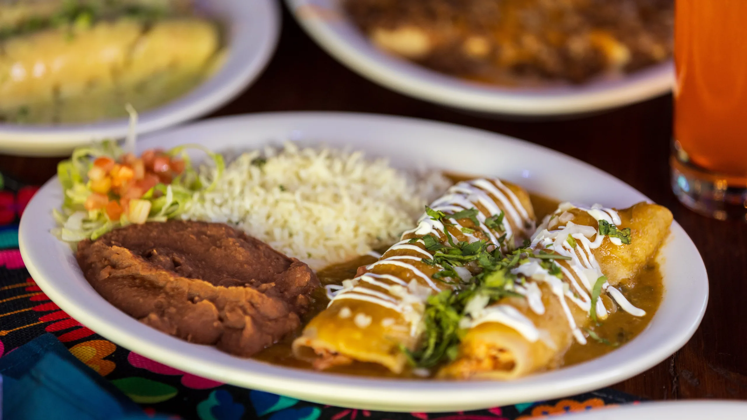 A freshly plated Mexican lunch of enchiladas, rice, and beans