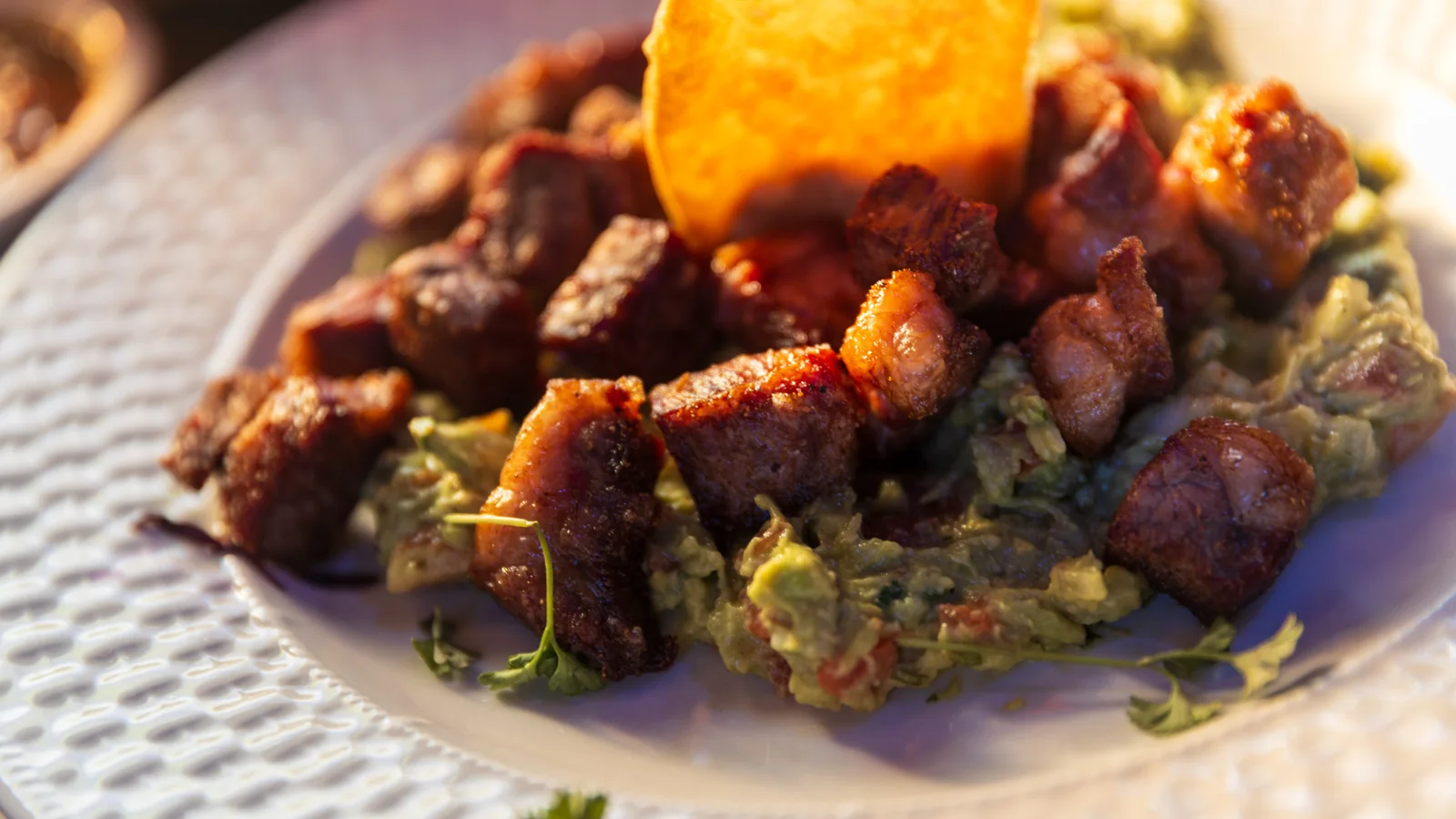 Crispy ribeye bites over fresh guacamole